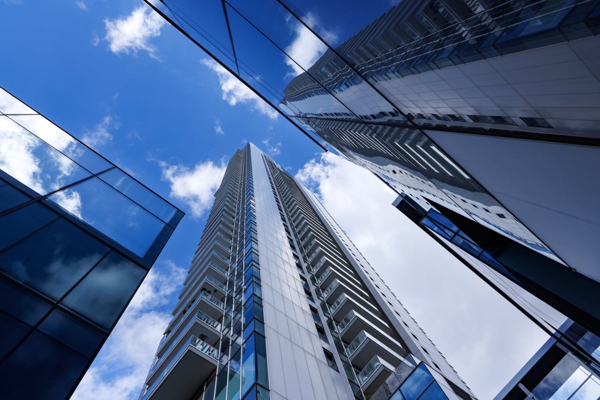 Modern skyscrapers and glass high rise buildings in Tel Aviv Israel viewed from below with dramatic perspective and blue sky. Contemporary urban architecture in a modern business district.